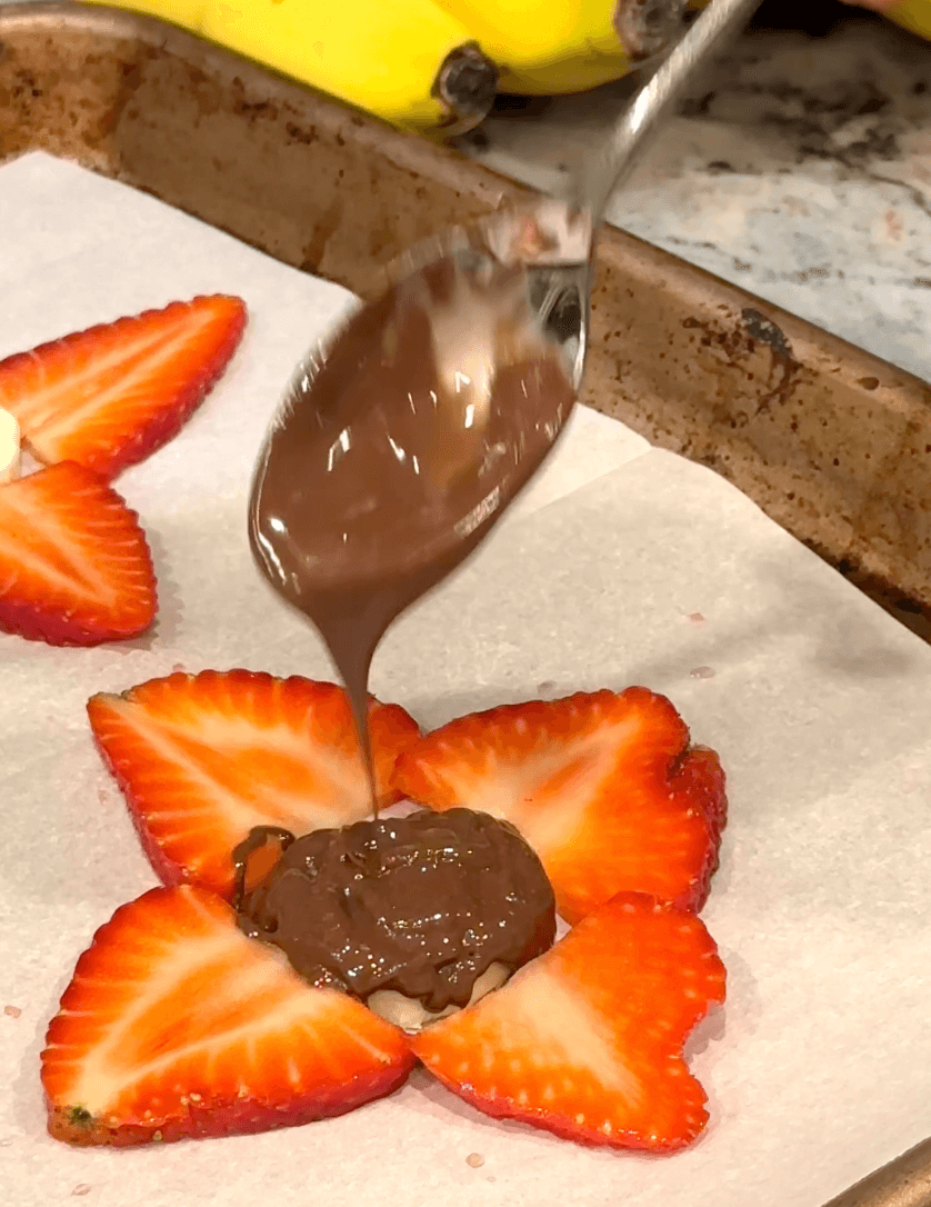 Chocolate spoon covering the strawberry and banana