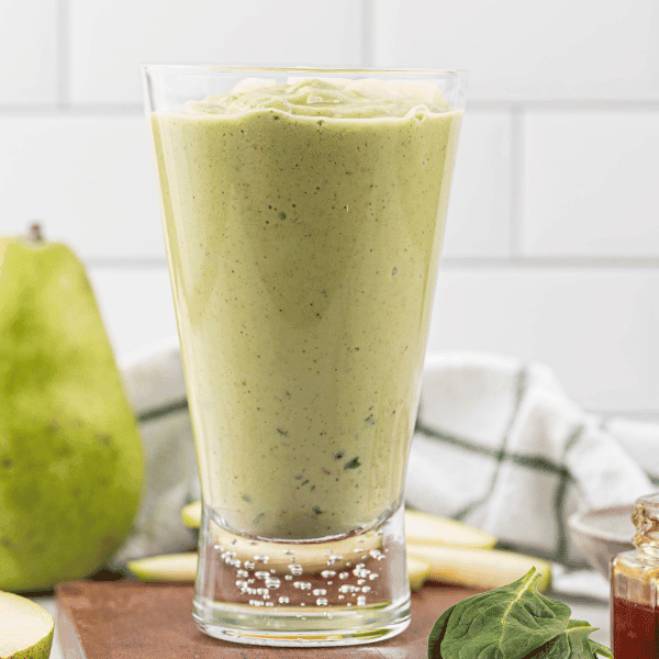 Green Pear Smoothie surrounded by green pear