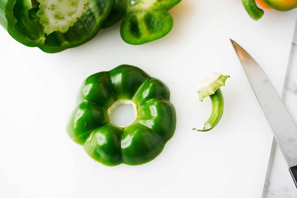removing the stem of the green bell pepper