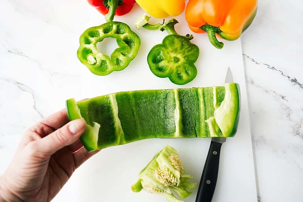 Opening up of green bell pepper after cutting it