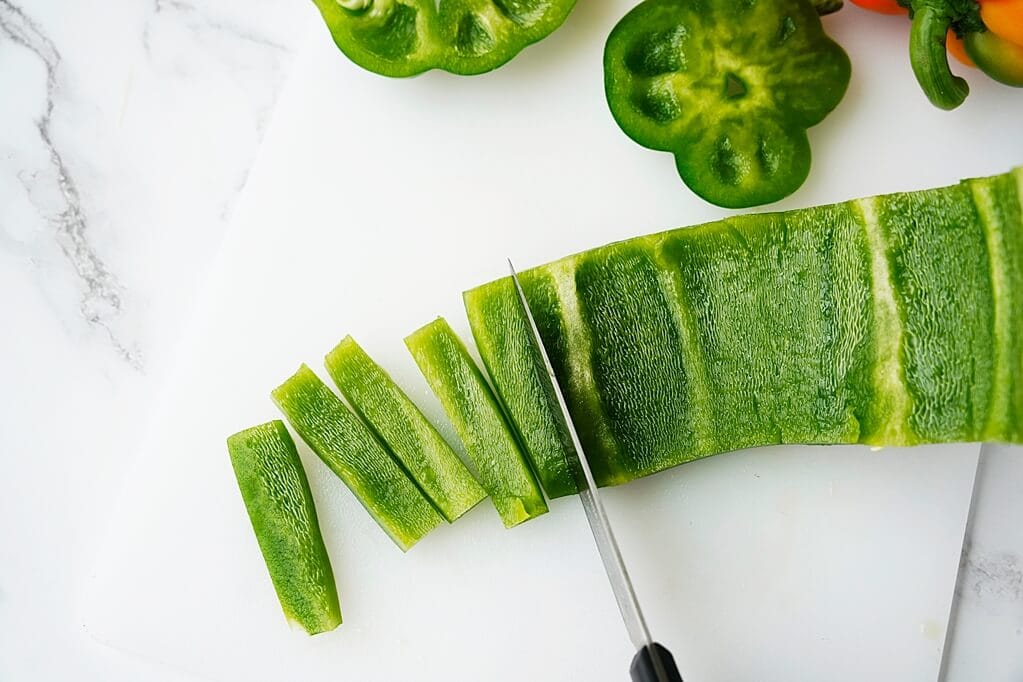 Cutting green bell pepper into sticks