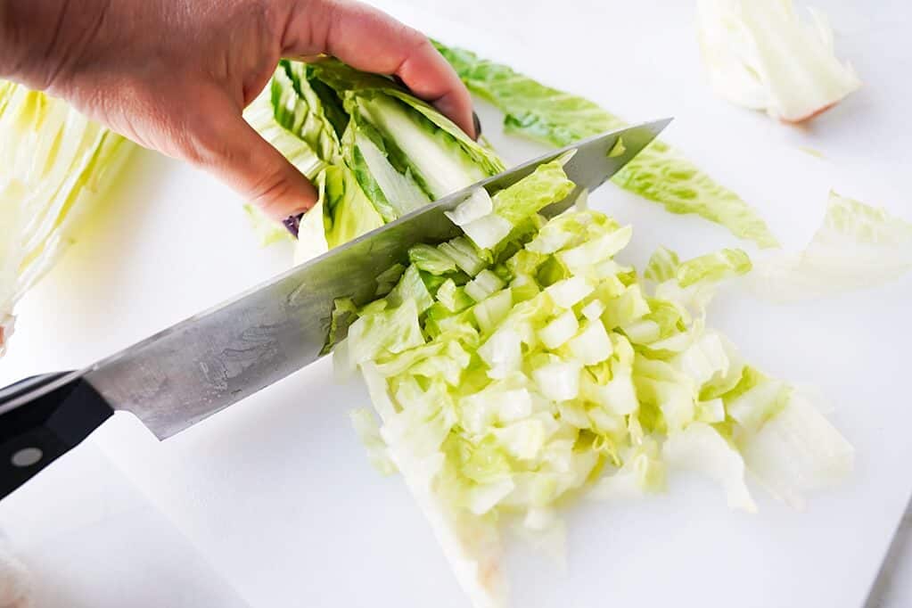 Step 4 of cutting romaine lettuce by chopping