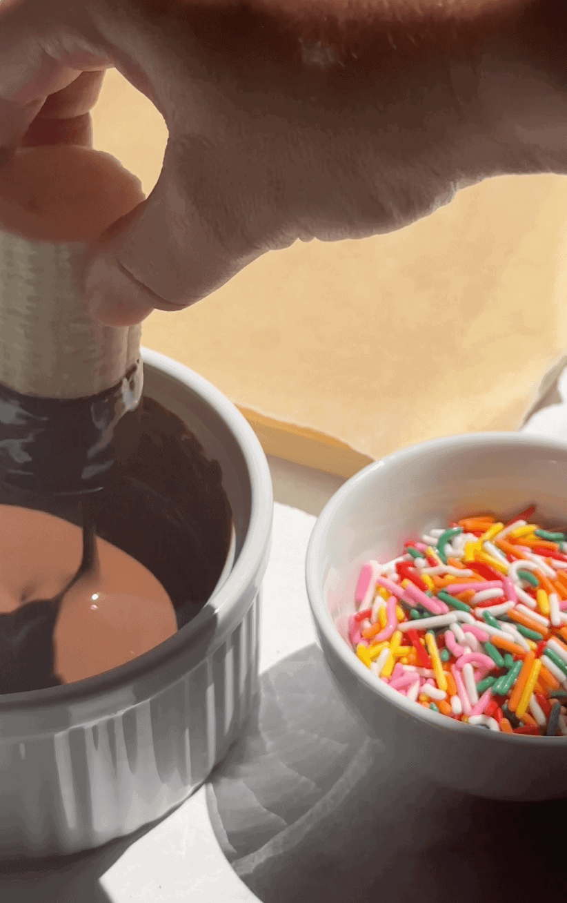 Dipping Banana bite into melted chocolate