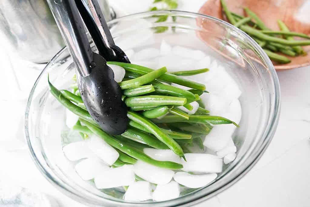 Dipping in green beans with ice bath