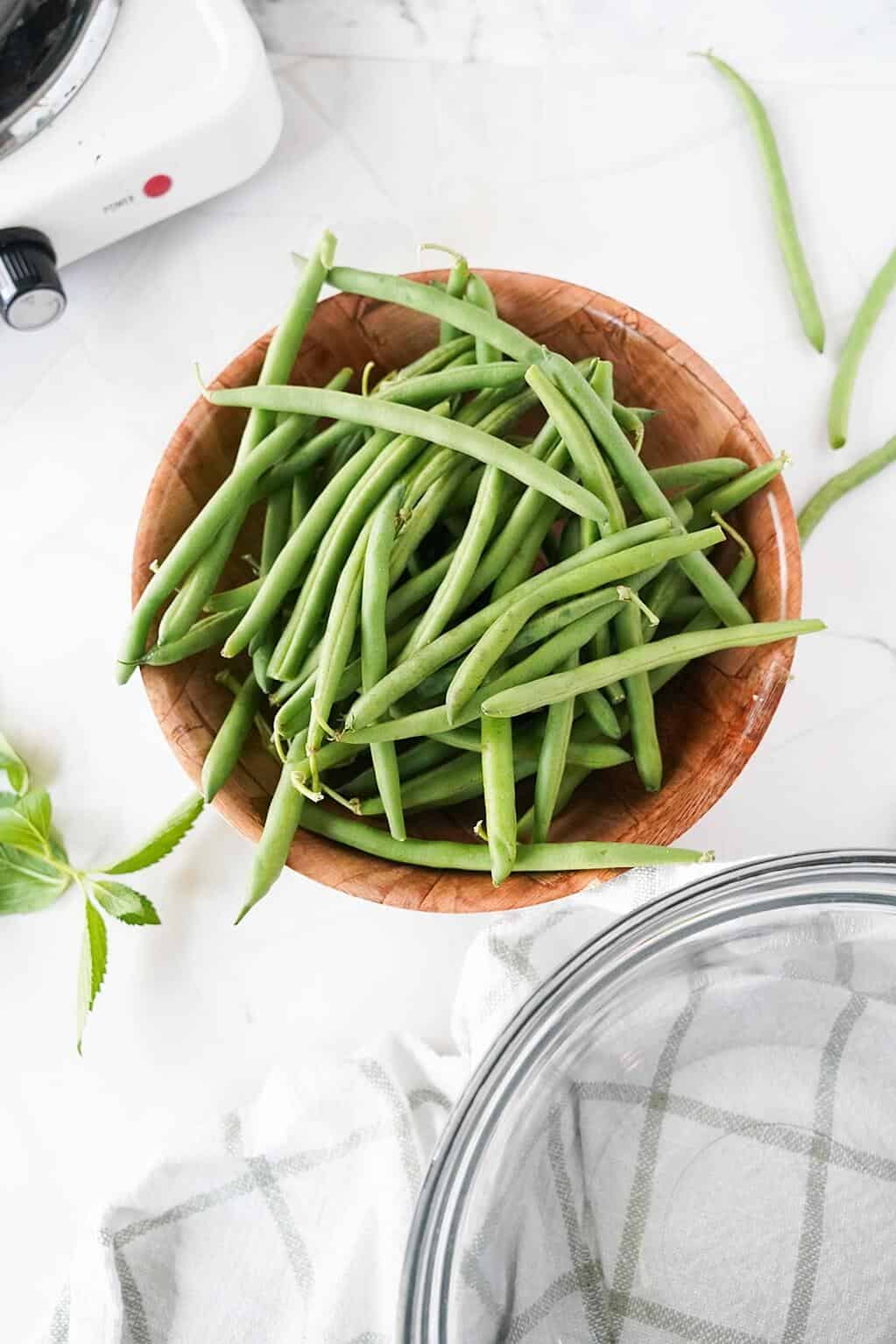 Vertical image of green beans in a bowl