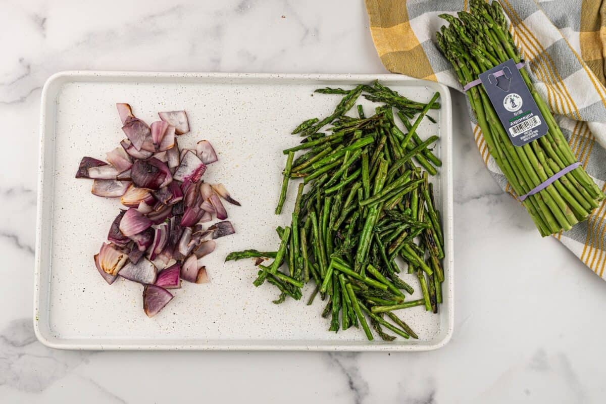 Chopped grilled onions and asparagus on a grill pan