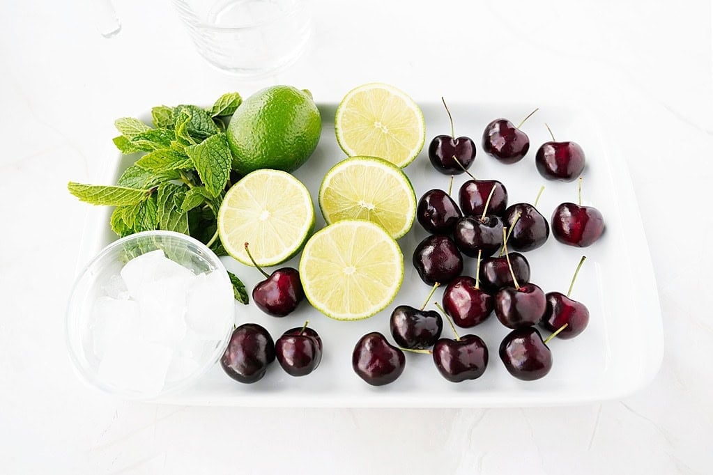 fresh cherries, limes, mint, ice, and sugar