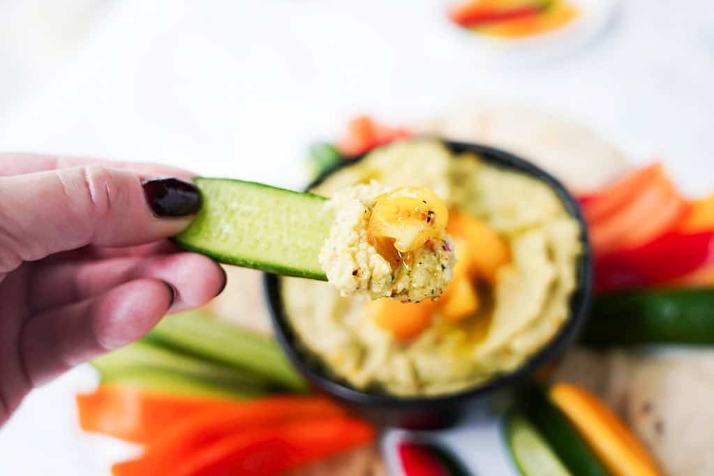 Cucumber dipped in Golden Tomato Hummus