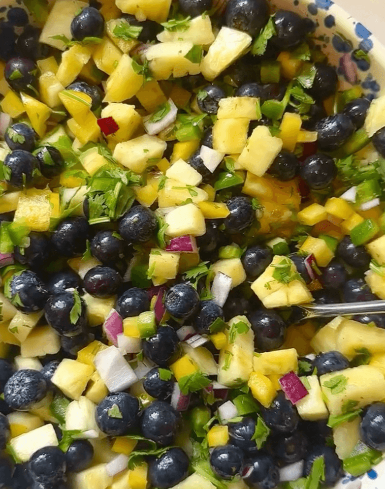 Mixing the blueberry pineapplele salsa ingredients