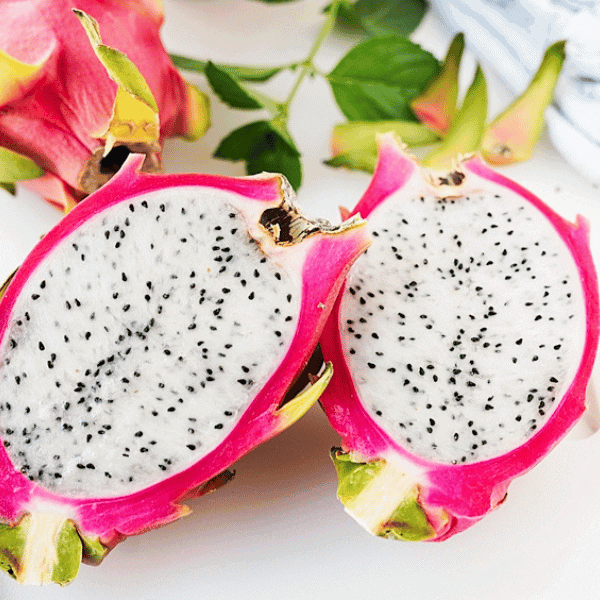 Split open dragon fruit exposing the white flesh
