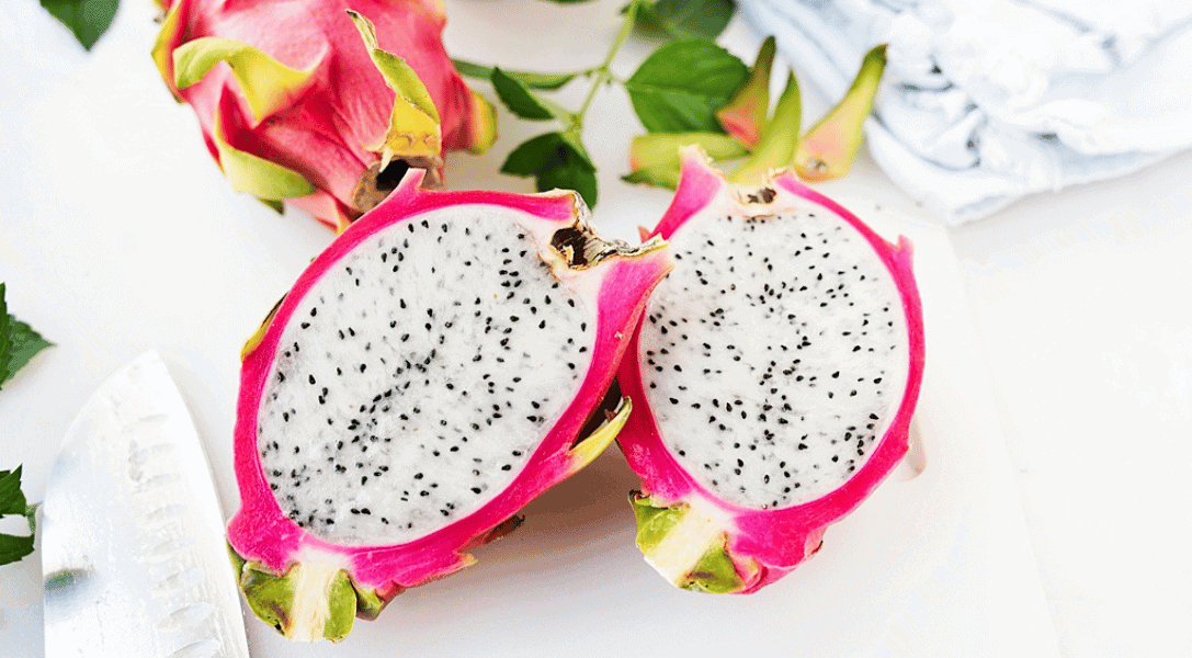 Split open dragon fruit exposing the white flesh