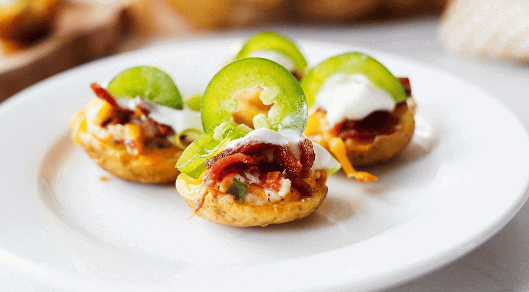 Jalapeno popper potato skins on white plate