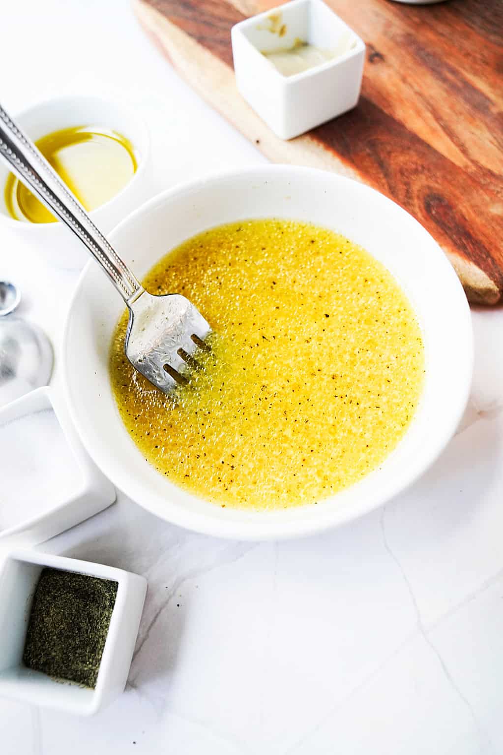 Citrus champagne vinaigrette ingredients in a small bowl