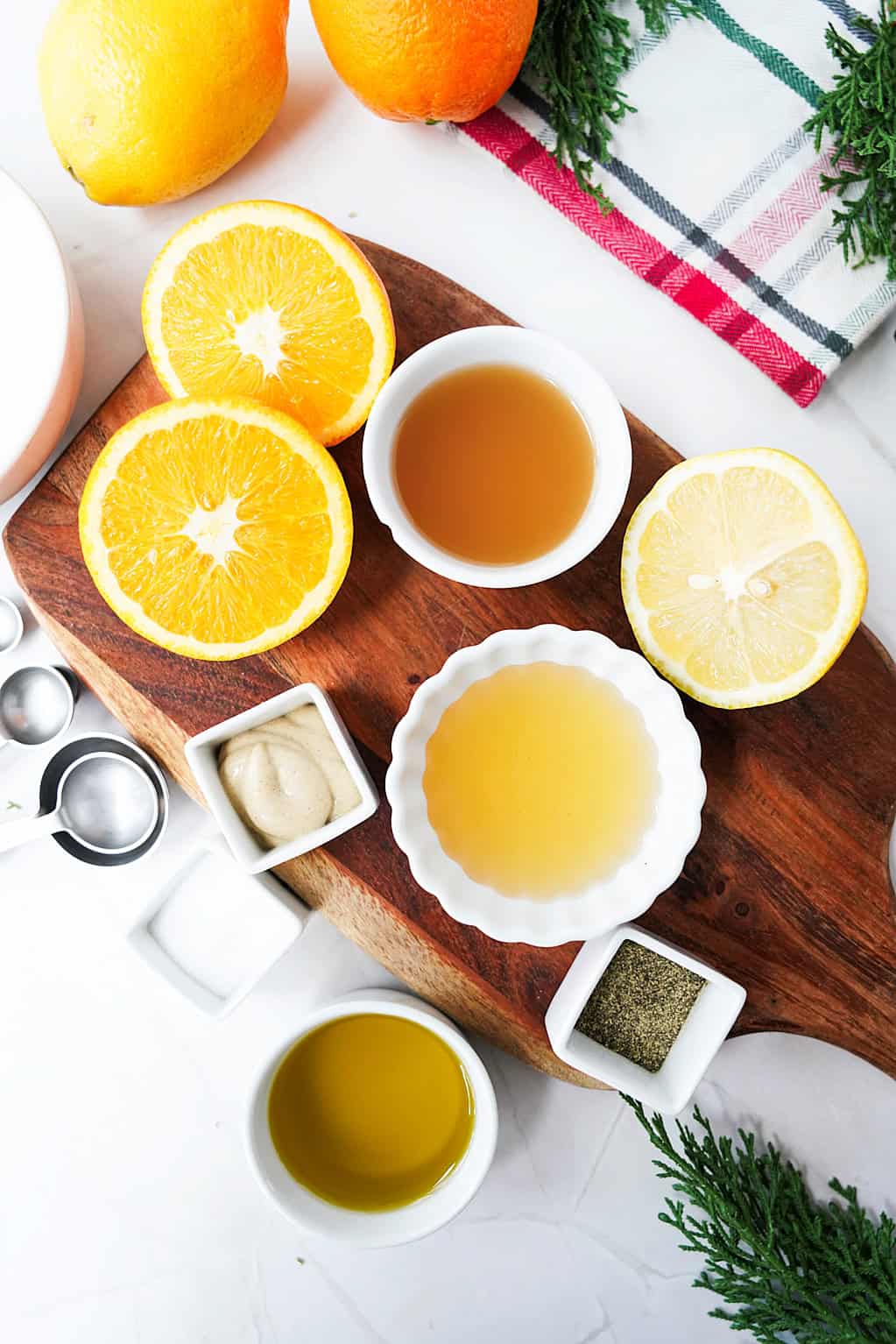 orange juice, lemon juice, Dijon mustard, salt, pepper, champagne vinegar, and olive oil