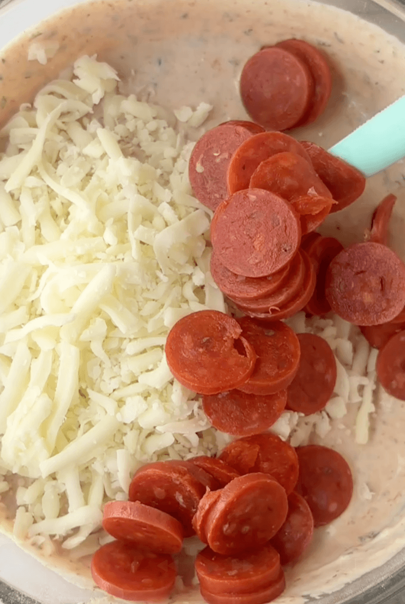 Folding pepperonis and mozzarella cheese into Ranch Pizza Dip base