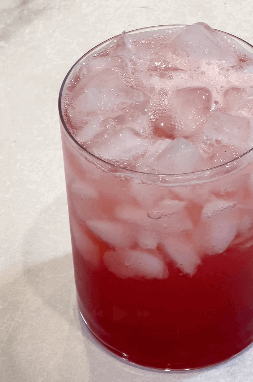 vertical shot of raspberry soda in glass