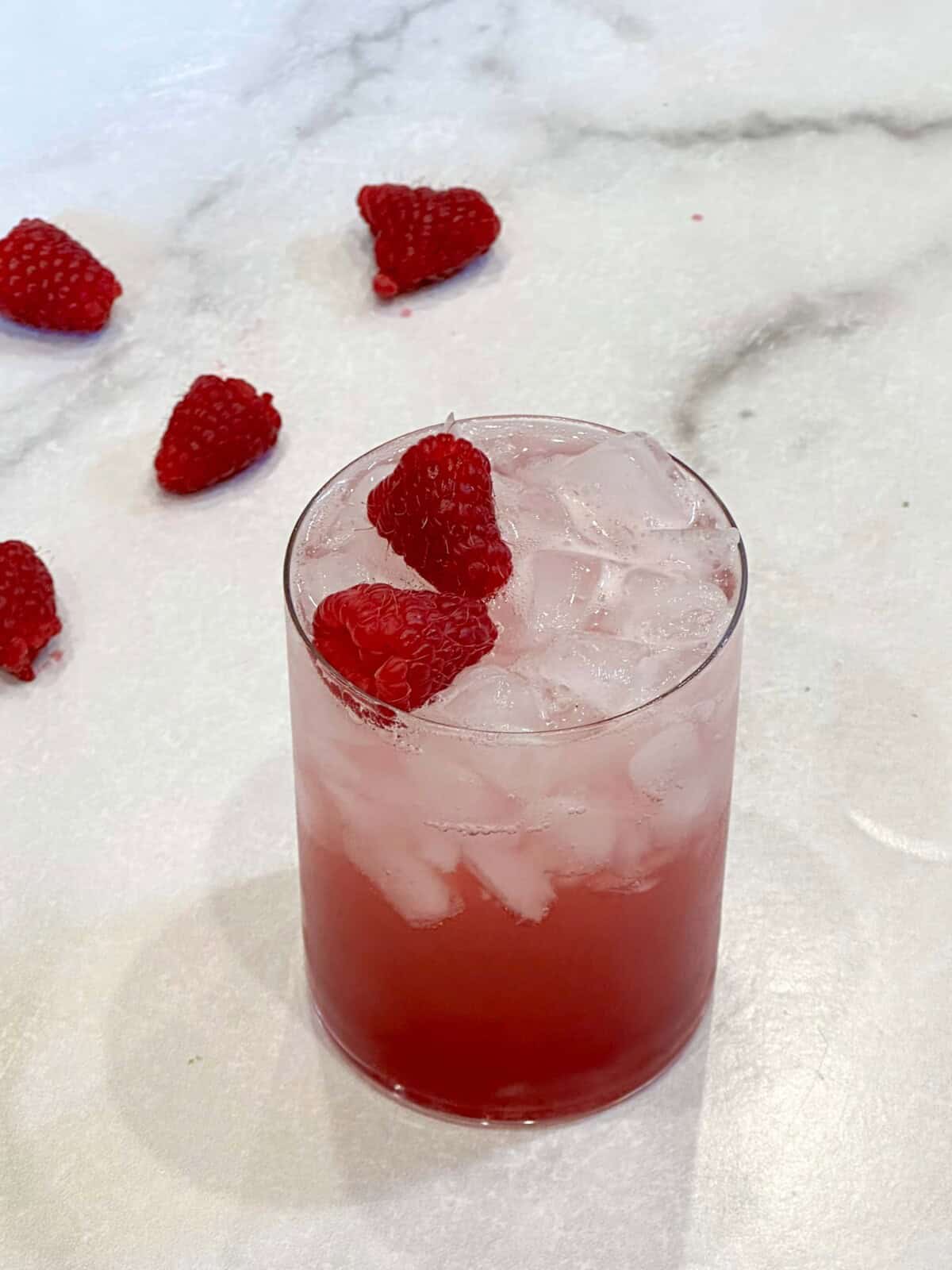 Vertical image of raspberry soda on counter