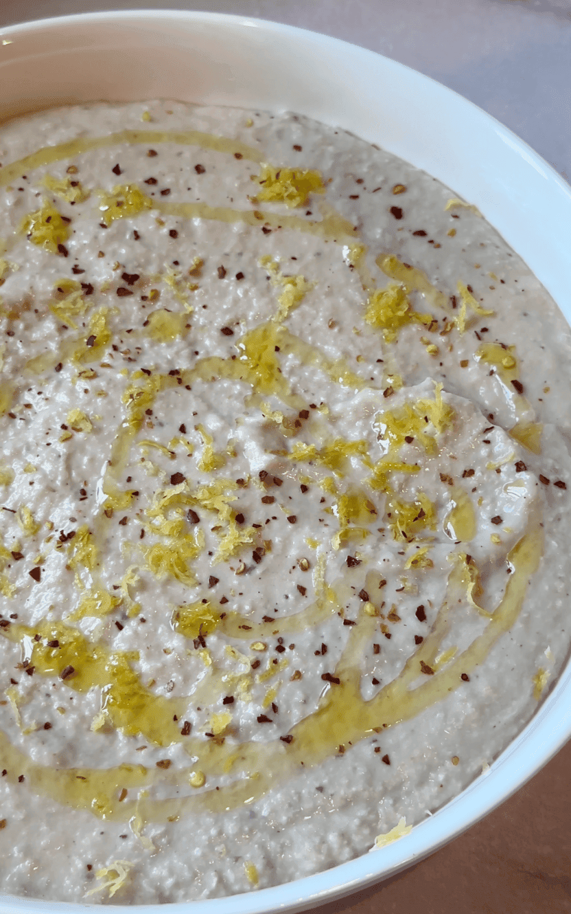 Vertical close up of the white bean artichoke dip