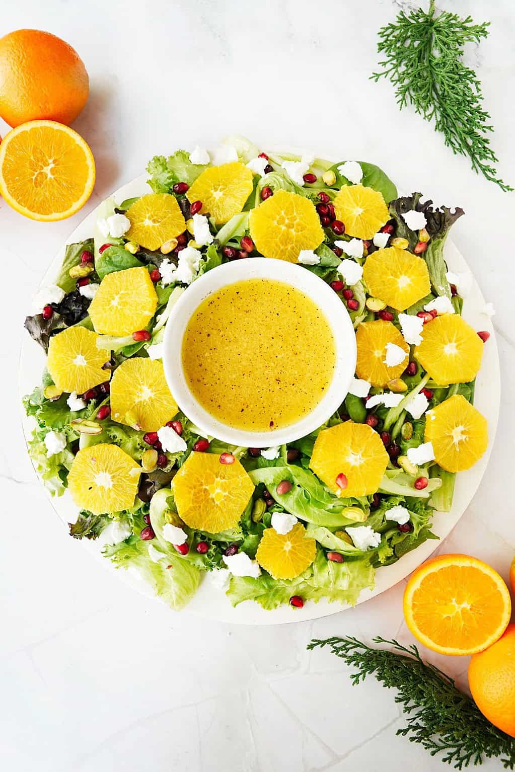 citrus wreath salad with orange halves and leafy decoration