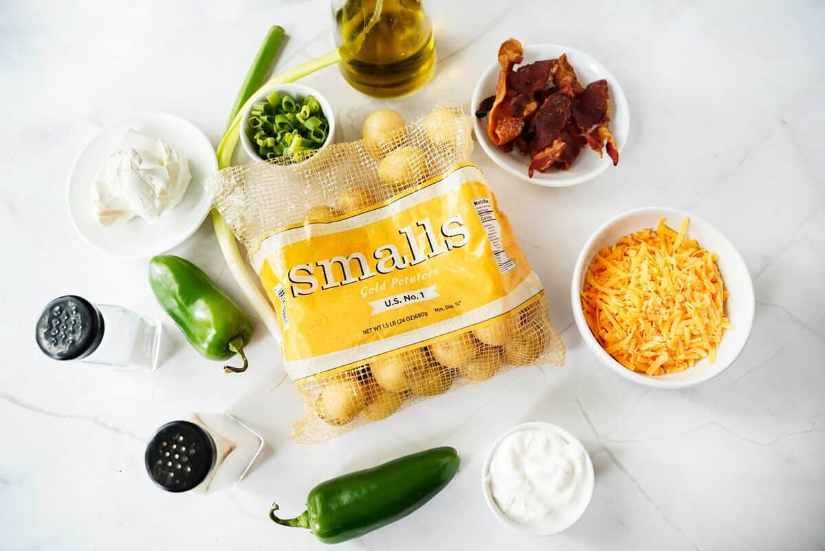 Smalls Artisan Potatoes, sharp cheddar cheese, creamy cheese, sour cream, bacon, green onions, jalapeños, olive oil