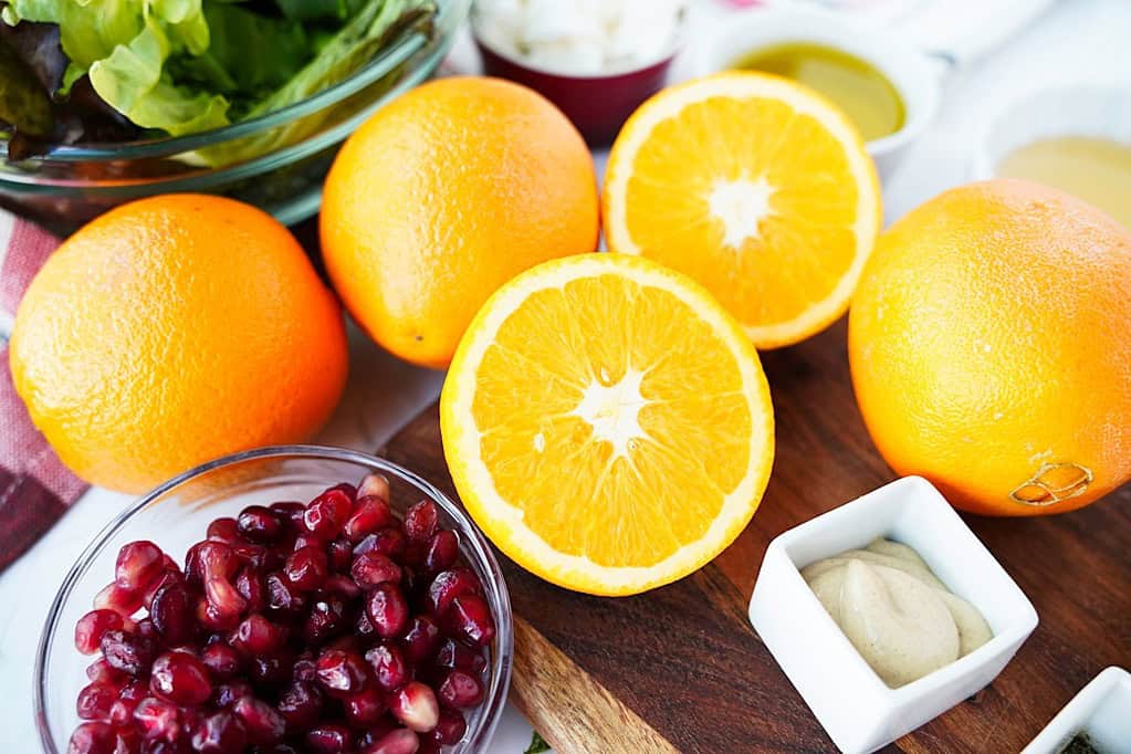 Oranges, pomegranate arils, Dijon mustard, and baby spring mix