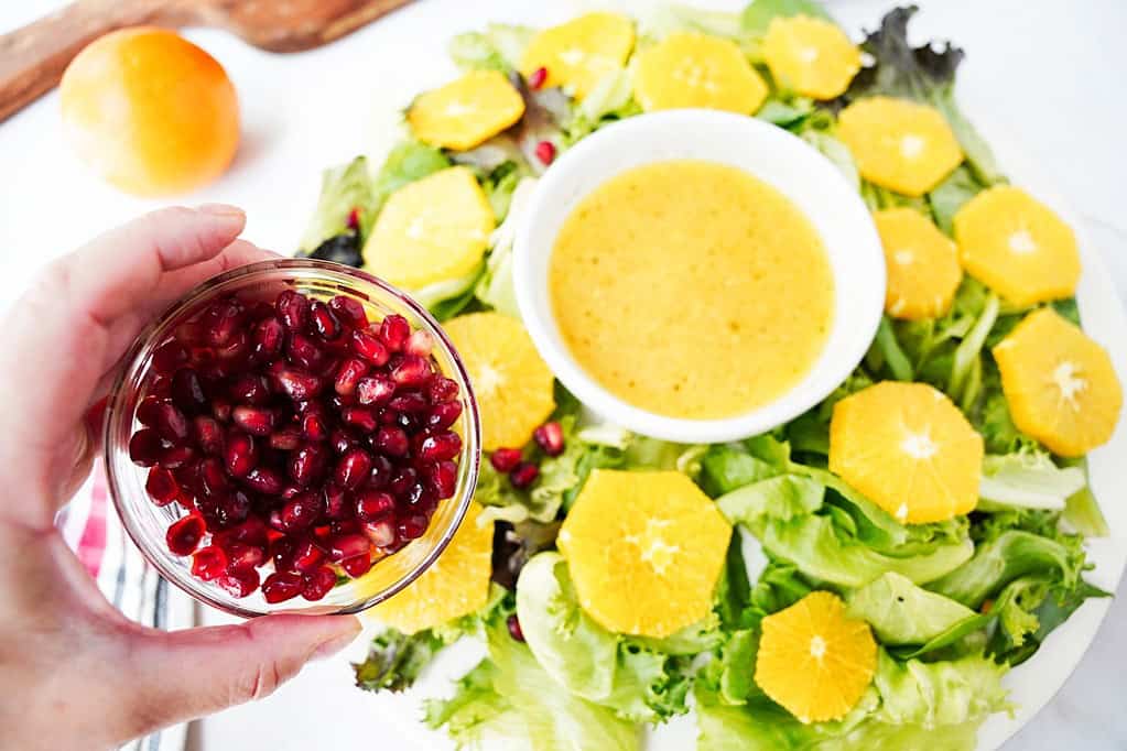 pomegranate arils sprinkled over the citrus salad wreath