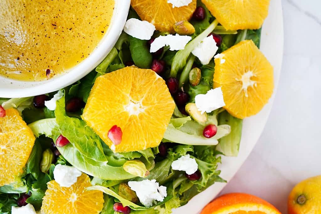 Citrus wreath salad with goat cheese, pomegranate arils, and pistachios sprinkled over the top