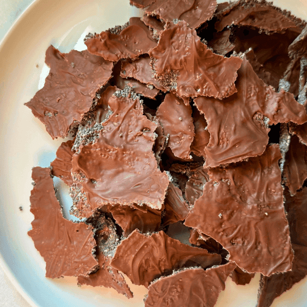 close up of chia seed chocolate crackers on white plate