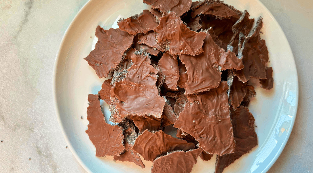close up of chia seed chocolate crackers on white plate