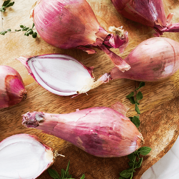 Shallots on wood board