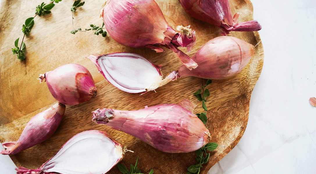 Shallots on wood board