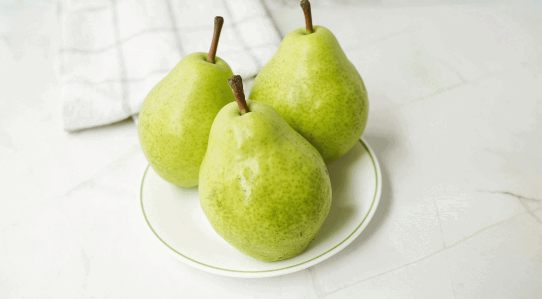 3 Green Bartlett Pears on a plate
