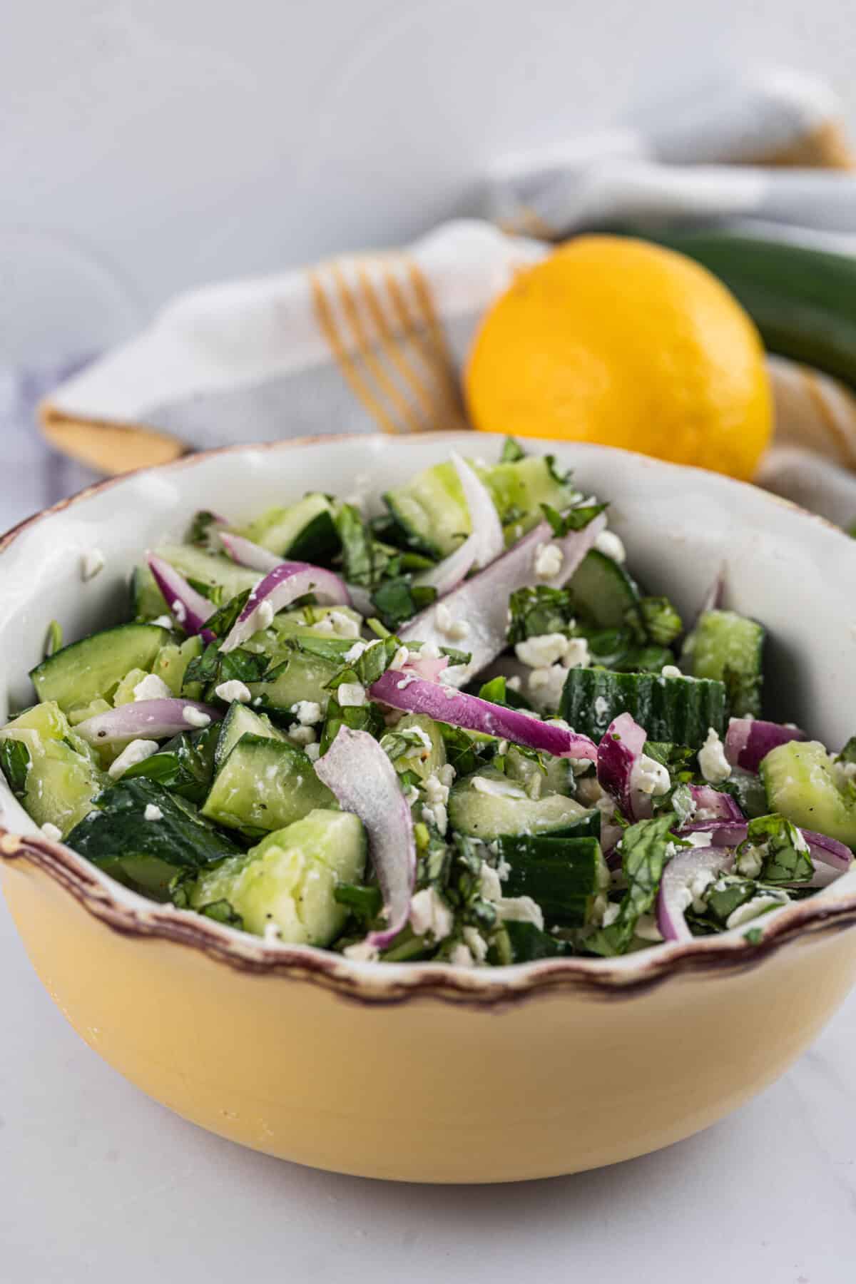 Dressed and tossed smashed cucumber salad in a large serving bowl.