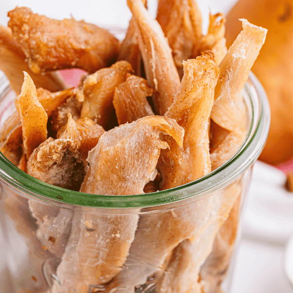 close up of Pear Chicken Jerky Dog Treat in mason jar
