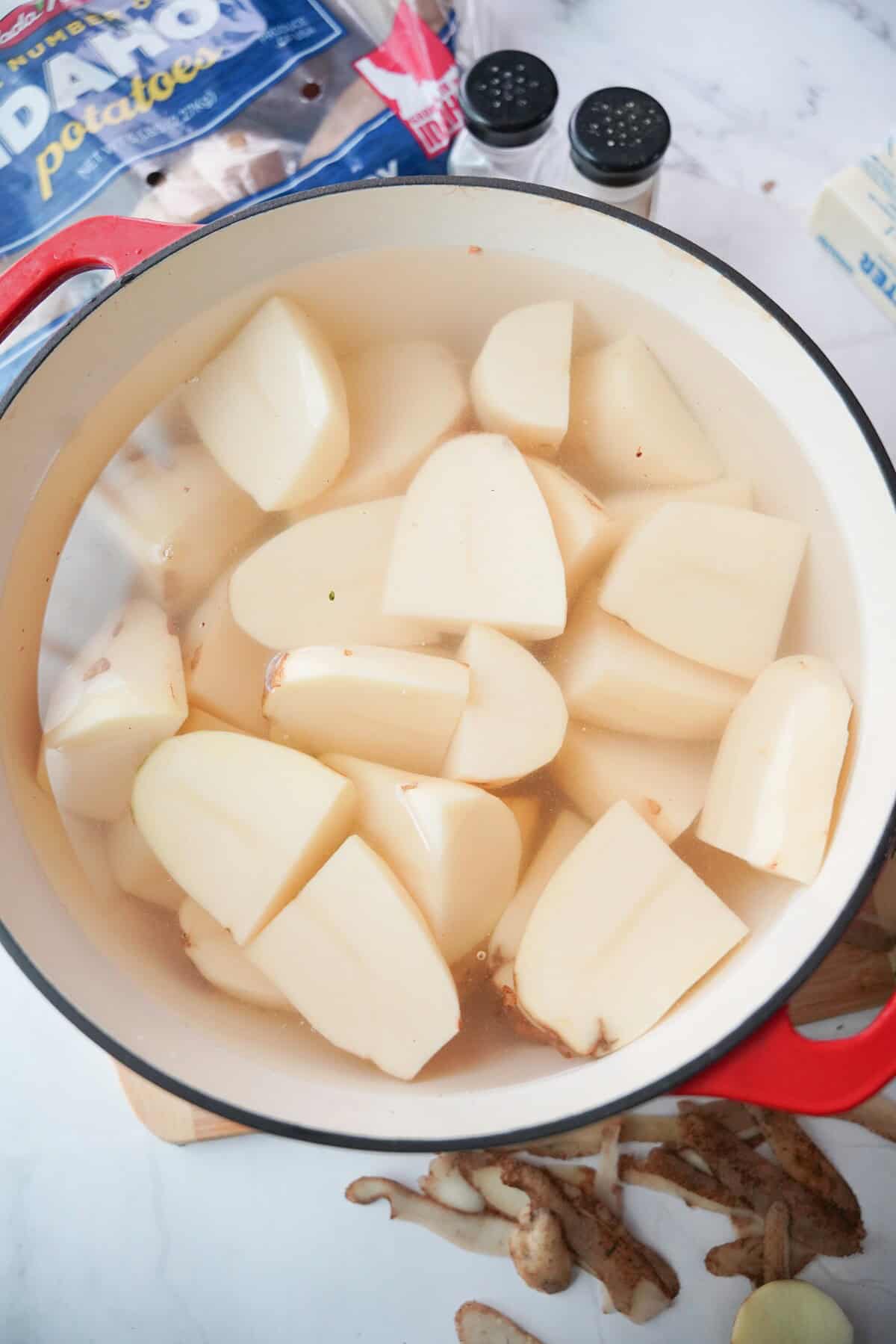 Quartered potatoes in a pot of salted water.