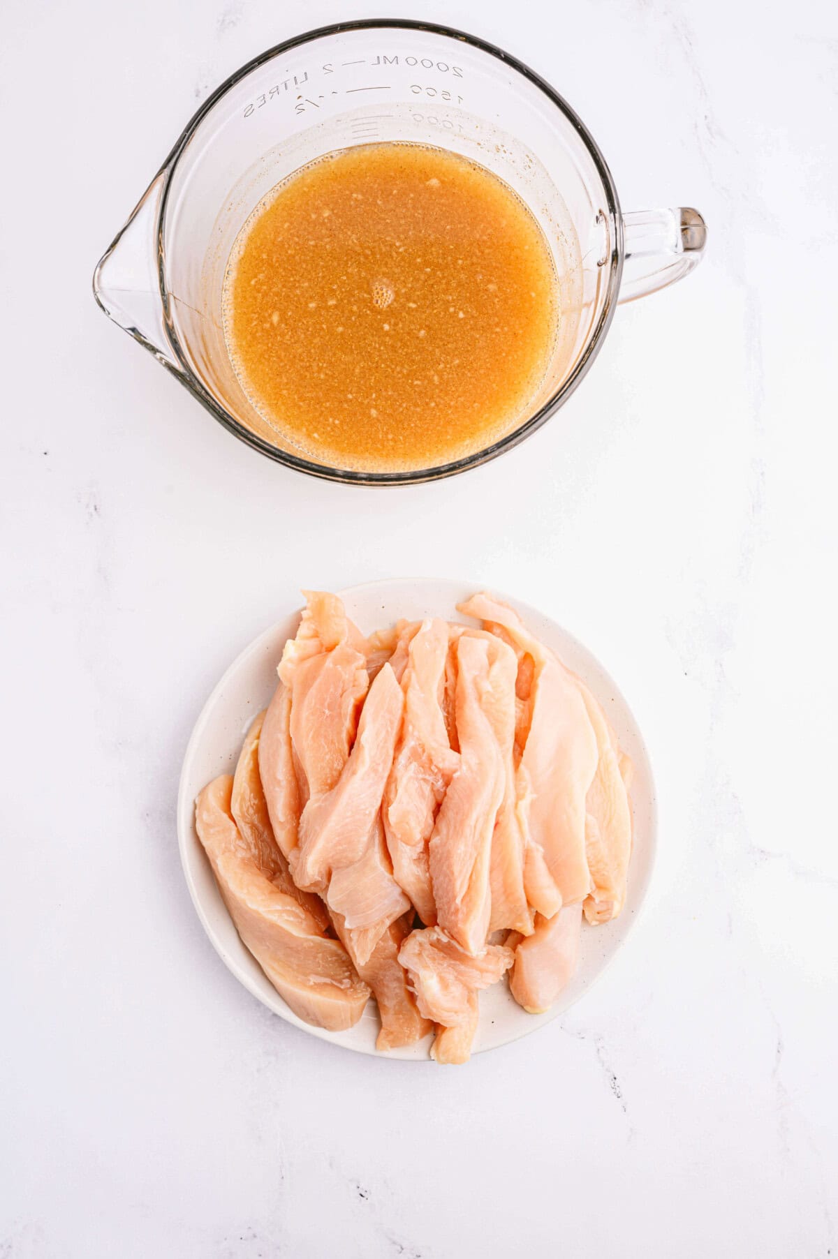 chicken waiting to go in bowl of marinade