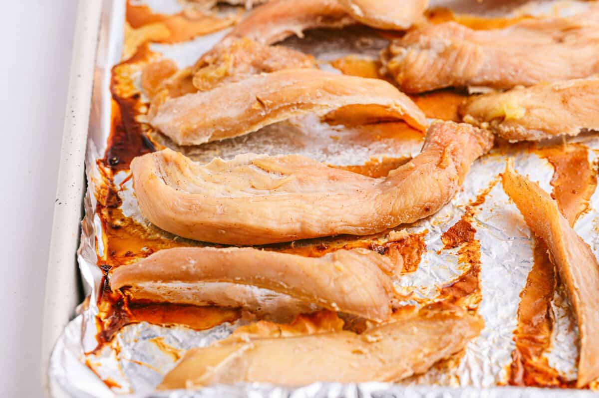 Pear Chicken Jerky Dog Treats on lined sheet pan
