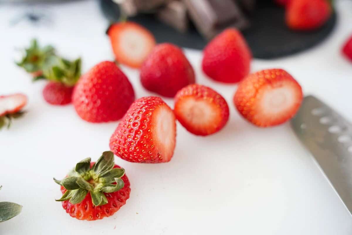 cut strawberries on cutting board
