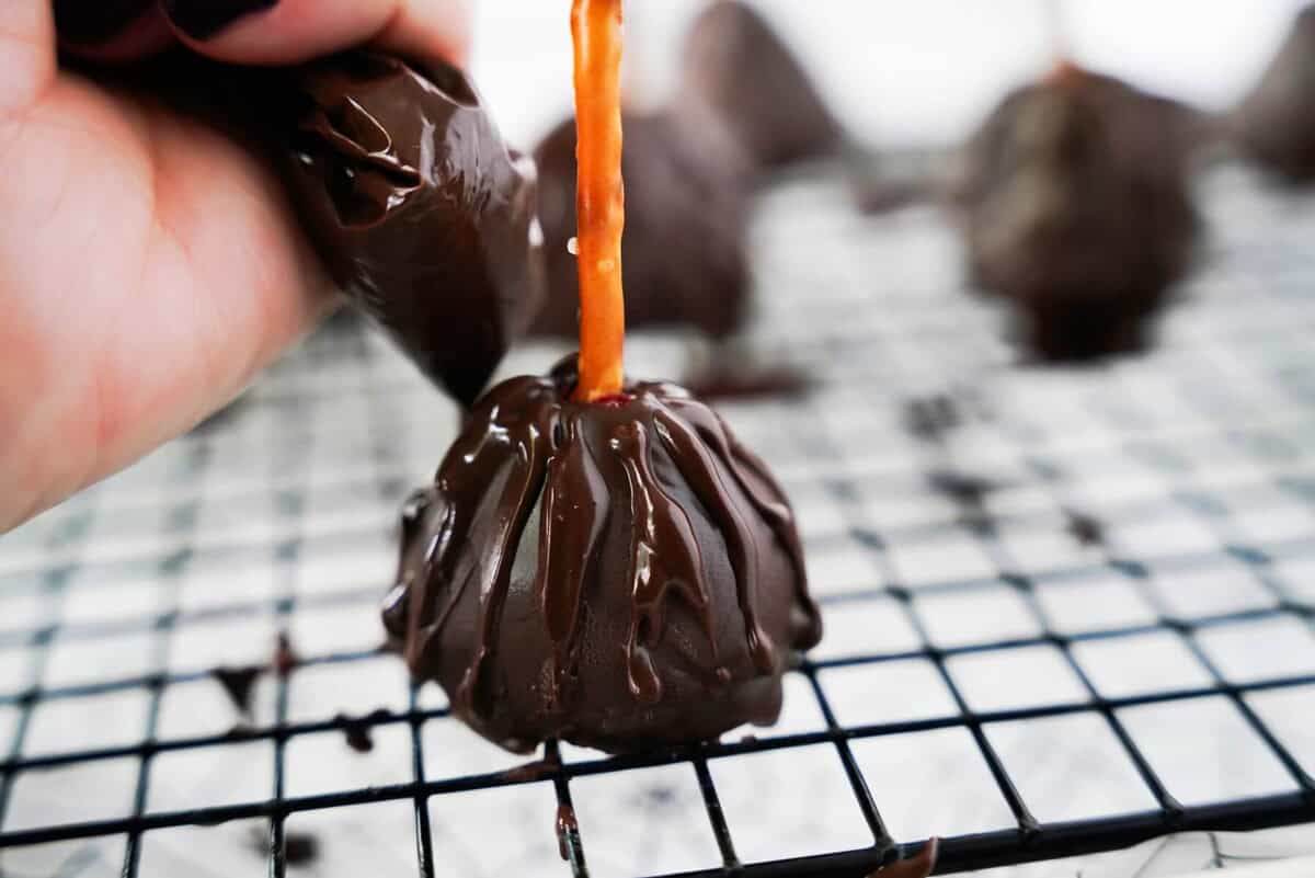 Piping chocolate on chocolate covered strawberries