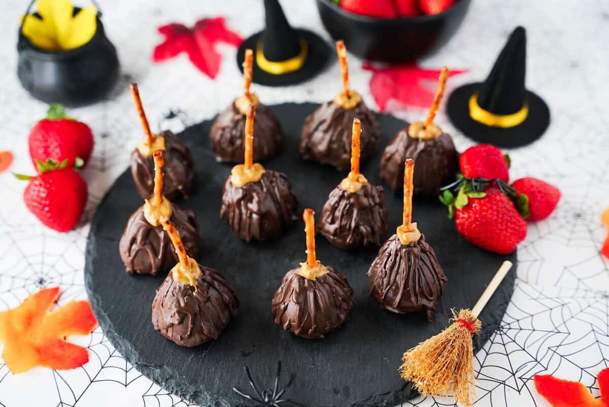 overhead view of strawberry witch brooms on black circular plate