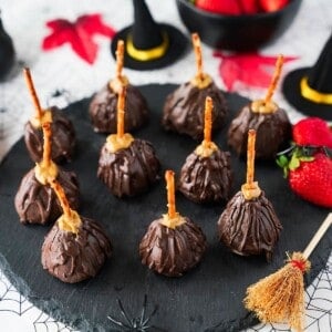 overhead view of strawberry witch brooms on black circular plate